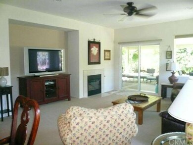 Big living/great room with custom carpet, tile fir