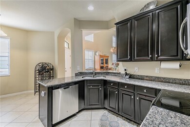 Kitchen with breakfast nook in the background.  No