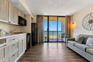 Living area featuring a textured ceiling, expansiv