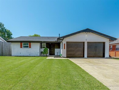 Ranch-style home featuring brick siding, driveway, a garage, and roof with shingles