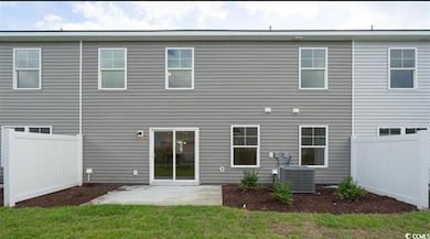 Back of property with a patio area, a yard, centra