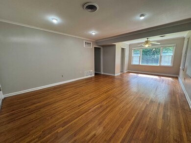 Large area with flexibility to arrange to suit! Hardwood floors throughout, crown molding, and ceiling fan