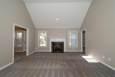 Another view of living room with fireplace.