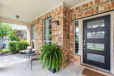View of exterior entry featuring covered porch an