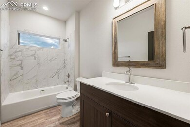 Bathroom featuring wood finished floors, vanity, toilet, and bathing tub / shower combination