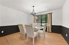 Dining area featuring a chandelier and wood finished floors
