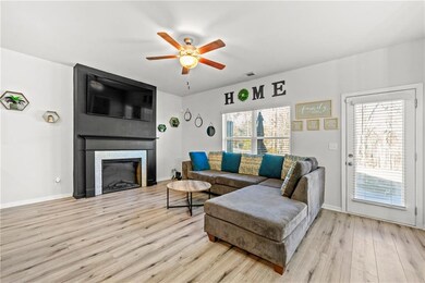 Living room featuring baseboards, wood finished fl