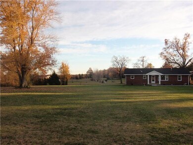 Sits back off the road... Beautiful home sits on 2.4 +/- acres.