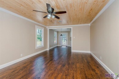 Formal living room with gleaming floors awaits you