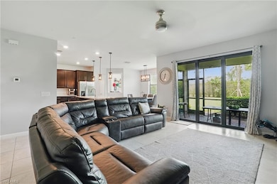 Living area with light tile patterned floors, recessed lighting, a ceiling fan, and baseboards