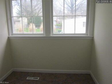 Dining area in kitchen has two large windows