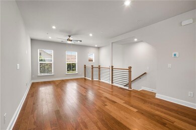 Spare room featuring hardwood / wood-style floors, a ceiling fan, baseboards, and recessed lighting