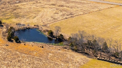 Aerial view of sparsely populated area featuring a nearby body of water