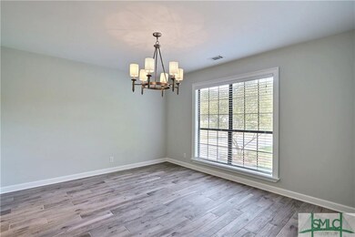 Formal Dining room with upgraded flooring and beau