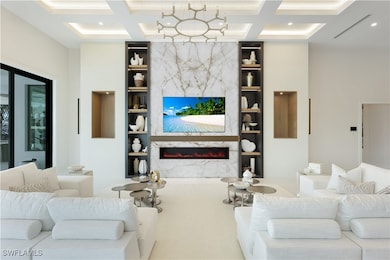 Living area featuring built in features, coffered