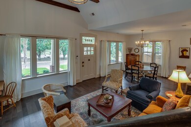 Living area with baseboards, visible vents, dark w