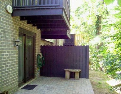 Exterior Back. Quiet wooded rear patio on lower le