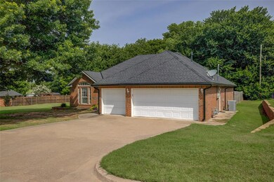 View of side of property featuring brick siding, concrete driveway, an attached garage, and roof with shingles