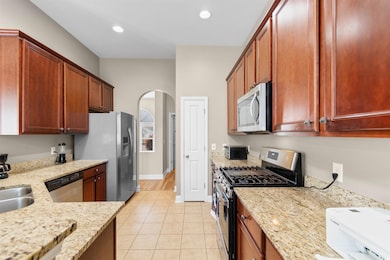 Kitchen featuring recessed lighting, arched walkwa