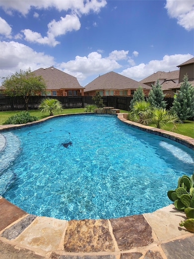View of pool with a fenced backyard