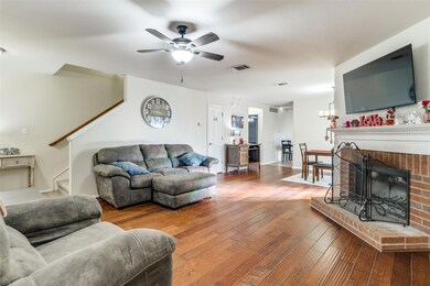 Open floorplan, tall  ceilings. wood floors,  elegant fireplace grounds the room.  Door just to right on main sofa is the half bath powder room.