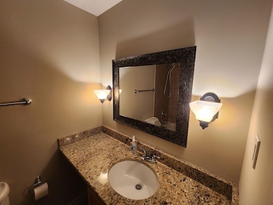 Bathroom with a shower, vanity, and toilet