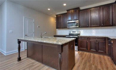 Kitchen featuring light wood-type flooring, an isl