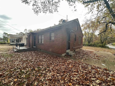 View of side of home featuring entry steps and bri