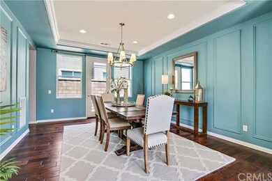 Formal Dining Room with coffered ceiling, French doors allowing access into side yard and courtyard