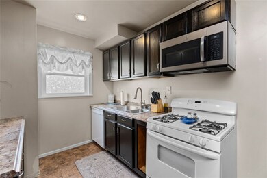 Espresso colored cabinetry.  Dishwasher, Gas stove