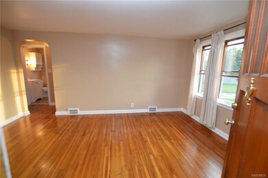 Large living room with hardwood floors has been pa