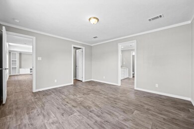 Unfurnished bedroom with hardwood / wood-style flo