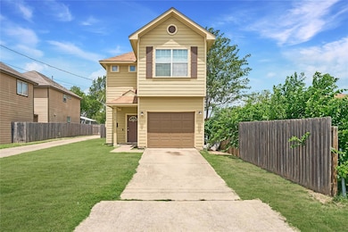 View of front of property with a garage and drive
