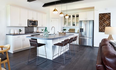 Kitchen featuring dark countertops, stainless ste