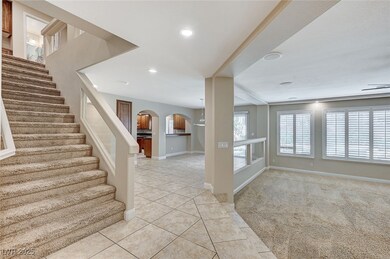 Foyer entrance featuring arched walkways, light ti