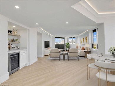 Expanded great room combing the dining and chef's kitchen featuring beverage cooler, crown molding with LED lighting