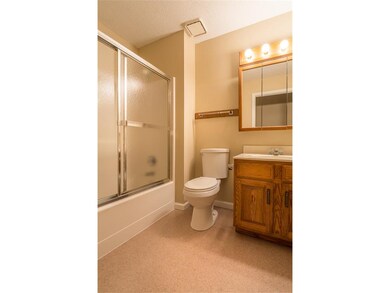 Main bath off hallway has high stool and shower-tu