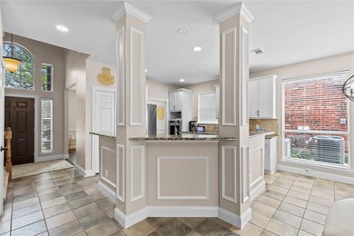 Kitchen with light tile flooring, white cabinets, 