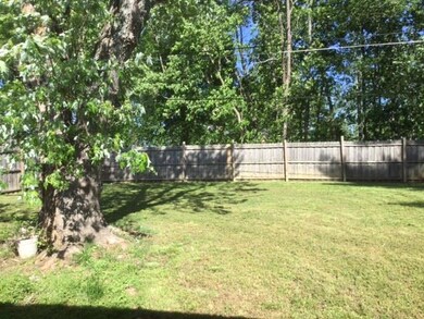 The back yard is large, level, shaded and fenced!