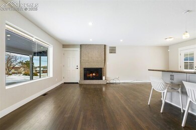 Unfurnished living room with dark wood-type flooring and a fireplace