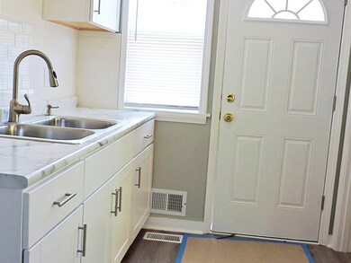KITCHEN. VIEW OF SIDE DOOR ENTRY. NEWER DOOR WITH STORM DOOR
