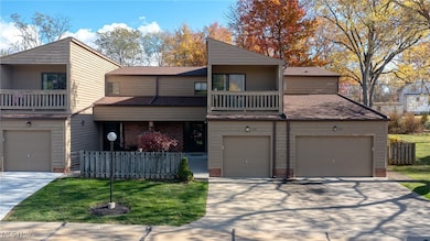 View of front of house with a balcony, a shingled roof, concrete driveway, and a garage