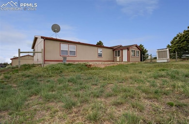 Back of property with chicken coop