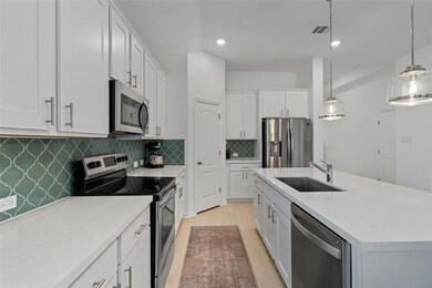 Kitchen featuring stainless steel appliances, lig