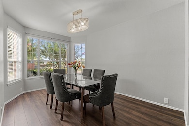 Dining room featuring dark wood-style flooring and plenty of natural light