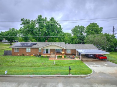 Ranch-style house with driveway, brick siding, roo