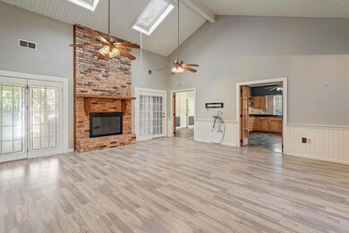 Spacious living area with fireplace and Cathedral