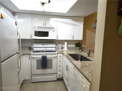 Kitchen featuring decorative backsplash, sink, whi