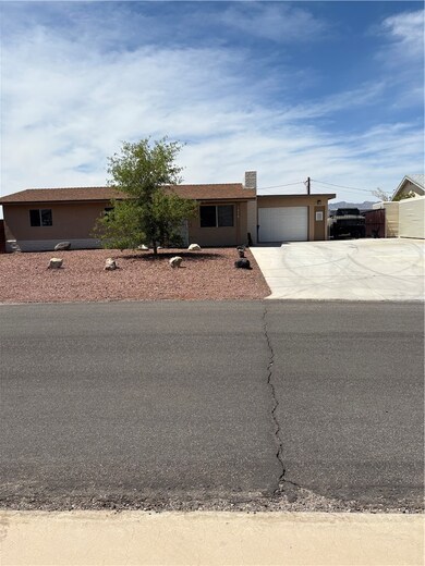 Single story home featuring concrete driveway, a g