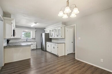 Kitchen featuring an inviting chandelier, applianc